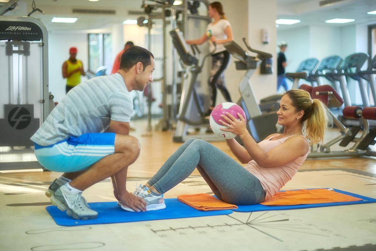Bahi Ajman Palace Hotel Exterior photo Personal trainer assisting a woman with sit-ups